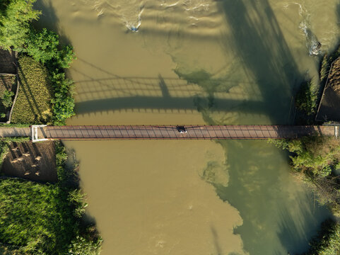 Bridge shadow over river