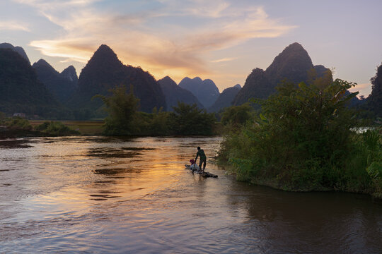 Sunset river with fisherman