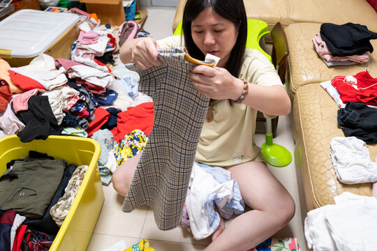 Sorting Clothes in a Messy Room in the Afternoon
