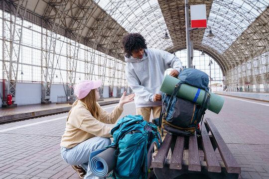 Backpackers meeting at railway station before journey