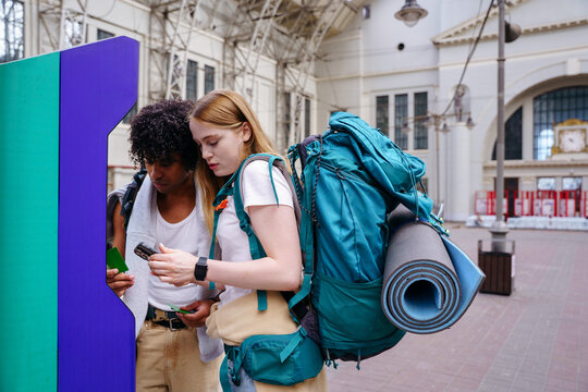 Backpackers at railway station before journey