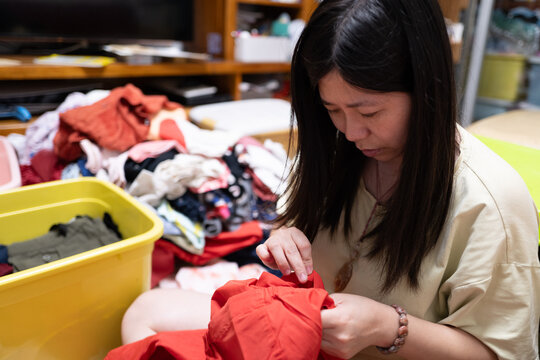 Sorting and Folding Clothes in a Living Room During the Day