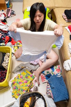 Sorting Clothes in a Living Room on a Weekend Afternoon