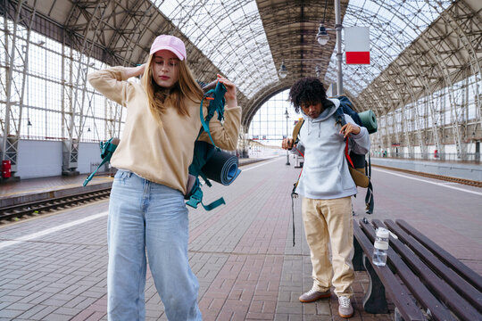 Backpackers meeting at railway station before journey