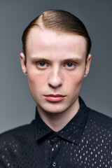 Fototapeta premium Young man showcases modern fashion trends in stylish studio setting