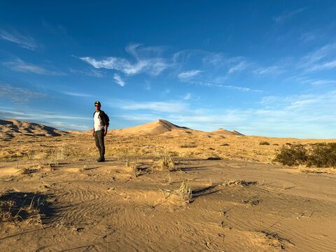 Man Taking Photo of Sand Dune in California Desert