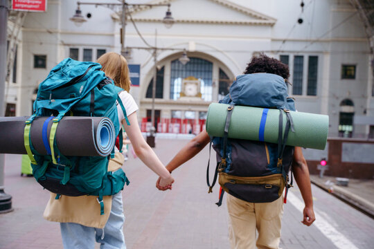 Backpackers at railway station before journey