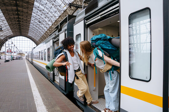 Backpackers at railway station before journey
