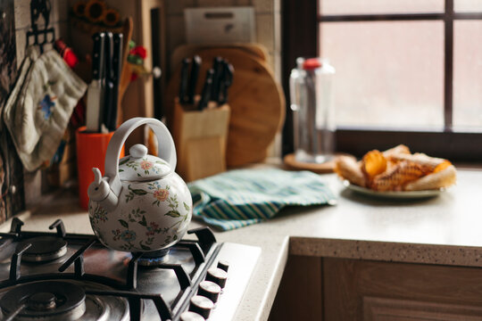 Cozy Kitchen Scene With a Floral Teapot and Warm Treats
