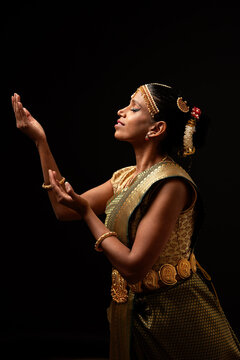 Indian bharatanatyam dancer performing mudra with devotion