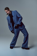 Fototapeta premium Stylish young man showcases modern fashion in a creative studio setting