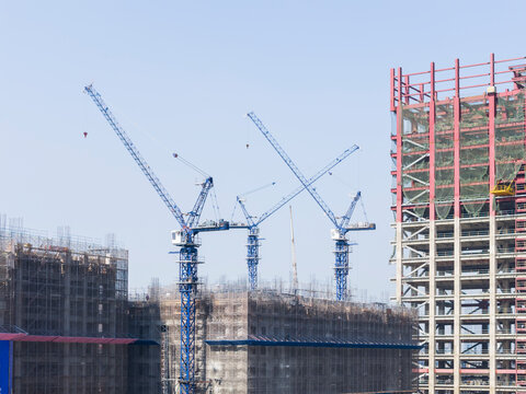 High Rise Construction Site with Blue Tower Cranes