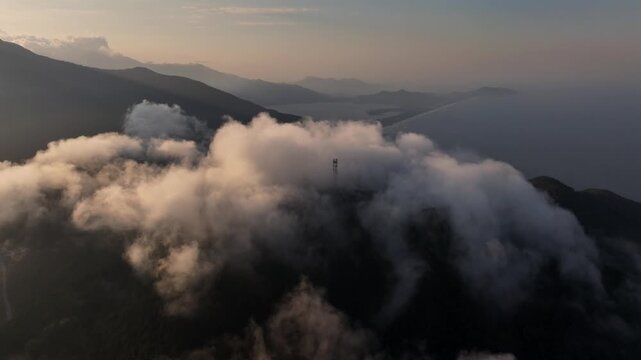 Clouds roll over Mountain ranges on Hai Van Pass, Da Nang, Vietnam, South East Asia. Aerial drone view at Sunset Time.