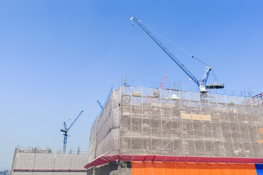 Construction Site with Tower Cranes and Scaffolding