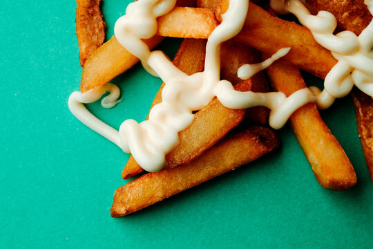a cropped view of fries with mayonnaise