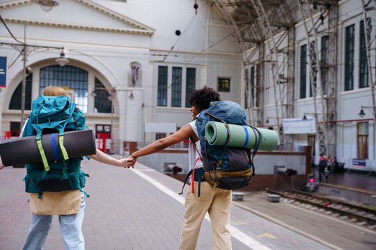 Backpackers at railway station before journey