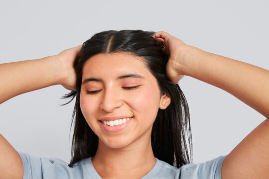 Young woman enjoying personal hair care happiness