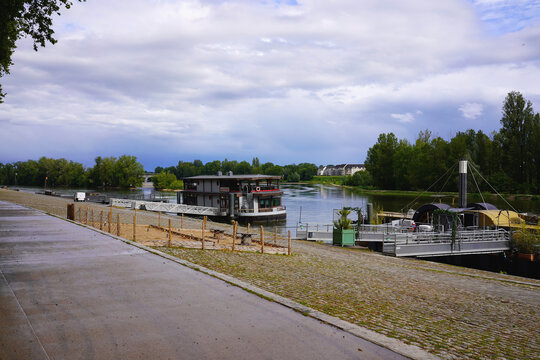 Scenic riverside view with moored boats on the Loire river in Orleans, France