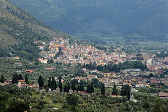 Panoramic view of Venafro, a historic town nestled on a hillside surrounded by olive groves and mountains in Molise, Italy