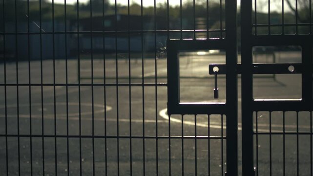 School gates with playground at dusk