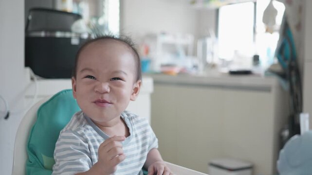 A joyful baby smiles brightly in a cozy room, capturing the essence of happiness and innocence. The cheerful atmosphere adds warmth to the scene, perfect for evoking feelings of joy and love.