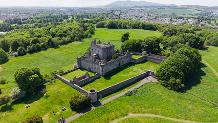 Beautiful aerial panorama of the majestic medieval Craigmillar Castle in Edinburgh, Scotland. Scenic view of the historic stone fortress and museum architecture with defensive walls, nestled among lus © MAKSYM