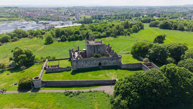 Majestic aerial view of the historic medieval Craigmillar Castle in Edinburgh, Scotland. Beautiful stone fortress and museum architecture with ancient battlements and defensive walls, surrounded by lu