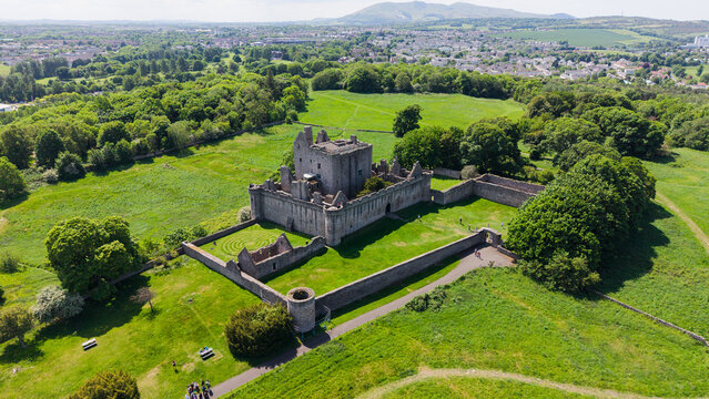 Beautiful aerial panorama of the majestic medieval Craigmillar Castle in Edinburgh, Scotland. Scenic view of the historic stone fortress and museum architecture with defensive walls, nestled among lus