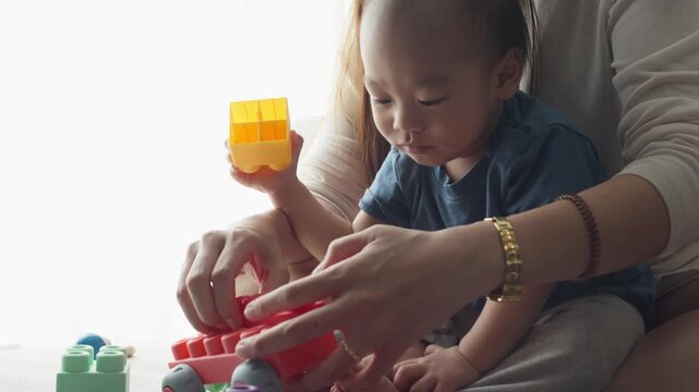 A young child engages in imaginative play with vibrant building blocks, fostering creativity and fine motor skills. The child explores various shapes and colors, creating a joyful atmosphere during pl