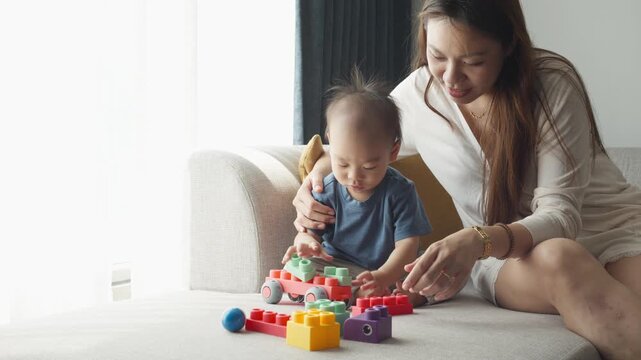 A joyful moment between a child and an adult as they explore colorful building blocks together. The atmosphere radiates warmth, creativity, and bonding, showcasing a delightful playtime experience.