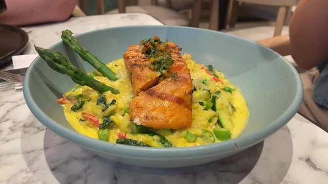 Delicious salmon rests atop creamy vegetable base