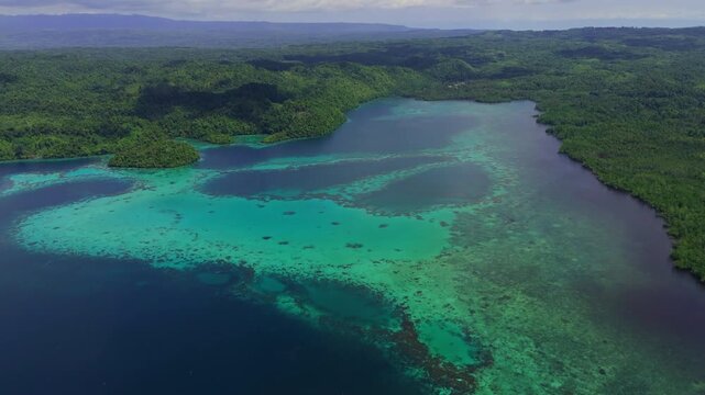 Epic cinematic tracking shot over majestic coastal landscapes of Banggai Sulawesi &ndash; Hidden tropical paradise islands with calm transparent lagoons, professional marketing video for travel tourism