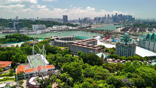Panoramic drone perspective of Sentosa Island showing coastline, attractions, and clear blue ocean