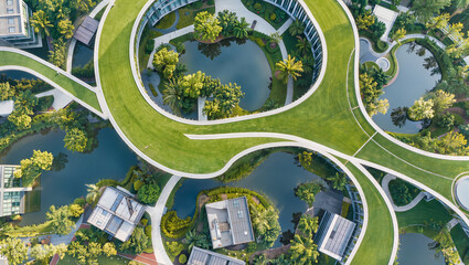 Fototapeta premium Aerial View of Modern Green Architecture with Curved Roofs and Ponds
