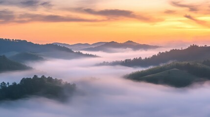 Obraz premium Hills blanketed in dense, low-hanging fog appear as soft, undulating shapes under a pastel sunrise sky, where the cool blues of the mist contrast with the warm, ethereal light touching the ridges.
