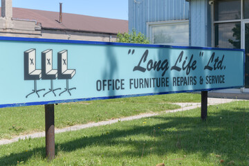Fototapeta premium vintage ghost sign outside Long Life Ltd, an office furniture store, located at 407 Birchmount Rd, Scarborough, Toronto