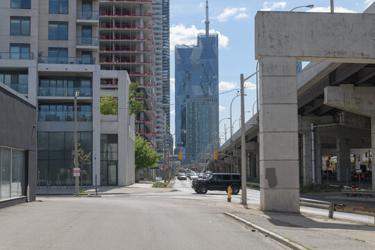 looking west from Lake Shore Blvd E (near crossing at Bonnycastle St) to hammerhead bents, elevated Gardiner Expressway, CIBC Square, and condos, Toronto