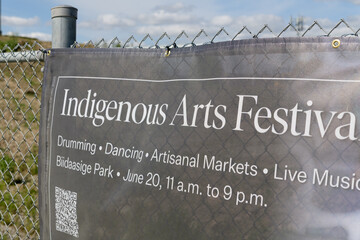 Fototapeta premium Indigenous Arts Festival banner on fence near Biidaasige Park, 51 Commissioners St, Port Lands, Toronto