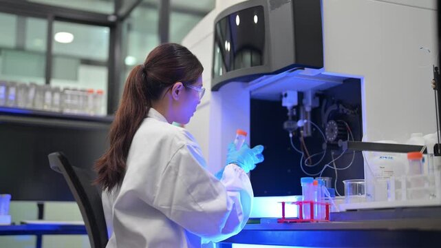 Scientist in lab coat and gloves performs experiment with test tubes and equipment