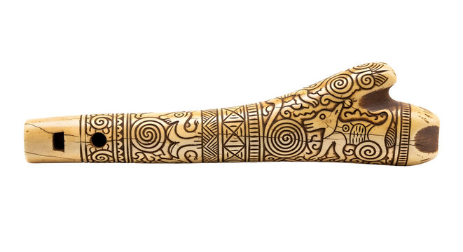 Ancient bone flute with intricate tribal carvings and zoomorphic designs