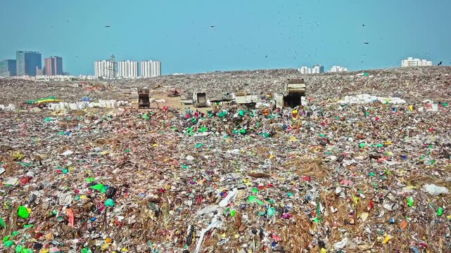 Bulldozer Segregating And Managing Waste At Active Landfill Site