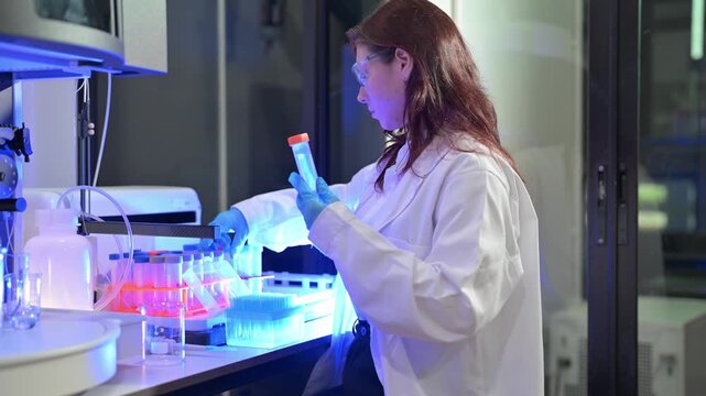 Scientist working with test tubes and equipment in a modern laboratory setting
