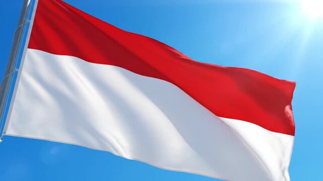 Red and white flag waving against bright blue sunny sky