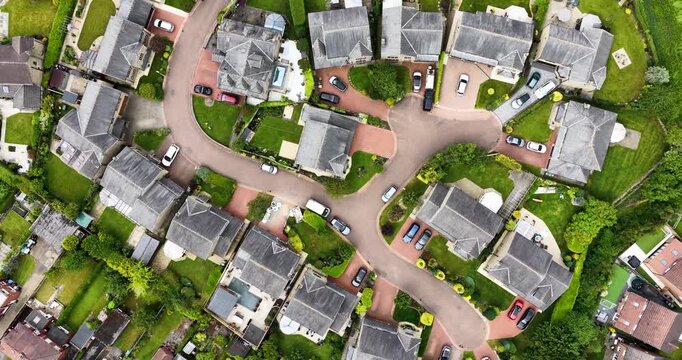 Aerial top down drone footage view of a residential cul-de-sac in Tingley Wakefield, West Yorkshire UK showing detached homes gardens roads and suburban neighbourhood layout in the summer time