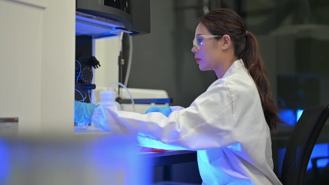 Scientist conducts research in lab setting with samples and equipment at a university