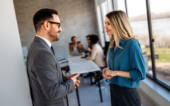 Business colleagues demonstrate teamwork, collaboration, communication, and strategy in office