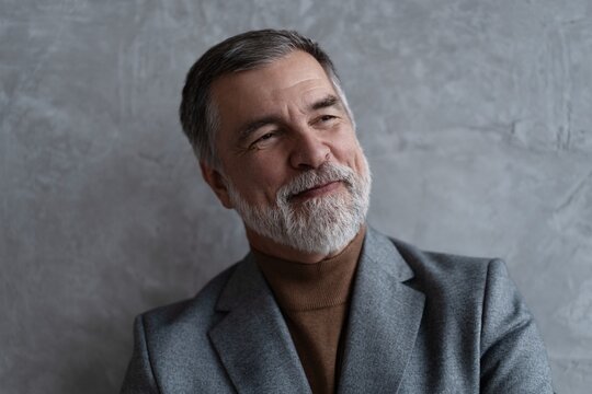 Entrepreneur in jacket smiling, Happy mid adult, mature age man standing, smiling, isolated on grey background