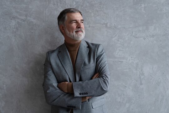 Entrepreneur in jacket smiling, Happy mid adult, mature age man standing, smiling, isolated on grey background