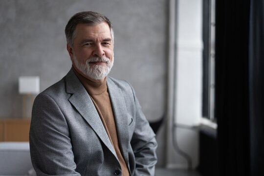 Portrait of a confident mature businessman near the window.