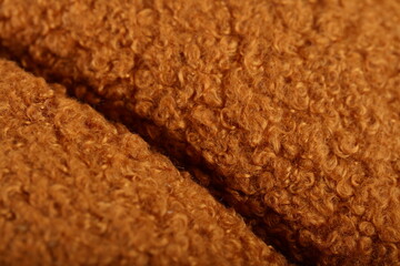 Extreme close-up full-frame texture of brown curly sherpa fleece teddy fabric material. © Imageologist